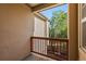 Balcony view with wood railing overlooking lush greenery, creating a serene outdoor space at 10578 E Jewell Ave, Aurora, CO 80012