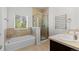 Bathroom boasts double sink, soaking tub, and glass shower at 10578 E Jewell Ave, Aurora, CO 80012