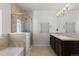 Bathroom boasts double sink, soaking tub, and glass shower at 10578 E Jewell Ave, Aurora, CO 80012