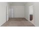 A bright carpeted bedroom features neutral walls, two entry points, and base molding at 10578 E Jewell Ave, Aurora, CO 80012