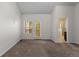 Bright bedroom features neutral carpet, closet, and sunny door to patio at 10578 E Jewell Ave, Aurora, CO 80012