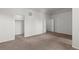 A bright carpeted bedroom features neutral walls, two entry points, and base molding at 10578 E Jewell Ave, Aurora, CO 80012