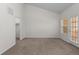 Bright bedroom features neutral carpet, closet, and sunny door to patio at 10578 E Jewell Ave, Aurora, CO 80012