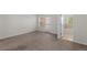 A primary carpeted bedroom boasts neutral walls, a door to a bathroom, and a door to an outdoor patio at 10578 E Jewell Ave, Aurora, CO 80012