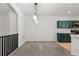 Bright dining area featuring a modern light fixture and green cabinetry at 10578 E Jewell Ave, Aurora, CO 80012