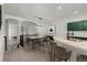 Upstairs dining area showcasing a breakfast bar and modern lighting at 10578 E Jewell Ave, Aurora, CO 80012