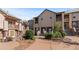 Inviting townhouse with stone accents, balconies, and well-maintained landscaping at 10578 E Jewell Ave, Aurora, CO 80012