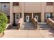 Close-up of townhouse entrances with stone accents and well-manicured landscaping at 10578 E Jewell Ave, Aurora, CO 80012