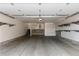 Spacious garage features epoxy floor, storage shelves, and stairs to home at 10578 E Jewell Ave, Aurora, CO 80012