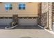 Garages are each marked with the unit number and have a stone facade at 10578 E Jewell Ave, Aurora, CO 80012