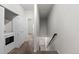 The hallway features stairs, carpet, a laundry closet, and neutral paint at 10578 E Jewell Ave, Aurora, CO 80012