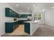 Open kitchen with an island, stainless steel appliances, and green cabinets at 10578 E Jewell Ave, Aurora, CO 80012