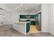 Bright kitchen with stainless steel appliances, island, and green cabinetry at 10578 E Jewell Ave, Aurora, CO 80012