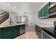 View of kitchen with stainless steel appliances and an open dining area at 10578 E Jewell Ave, Aurora, CO 80012