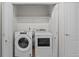 Modern laundry room with white washer and dryer at 10578 E Jewell Ave, Aurora, CO 80012