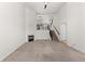 Open-concept living room with fireplace, archway to kitchen, and staircase at 10578 E Jewell Ave, Aurora, CO 80012