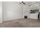 Spacious living room with a fireplace, neutral carpet, and open layout, connecting to other living spaces at 10578 E Jewell Ave, Aurora, CO 80012