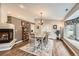 Elegant dining room with chandelier, hardwood floors, fireplace and french doors at 19475 Stag Ln, Monument, CO 80132
