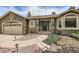 Inviting front entrance of a single-story home with lush landscaping and sidewalk at 19475 Stag Ln, Monument, CO 80132
