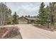 Single story home with a long driveway and well manicured landscaping at 19475 Stag Ln, Monument, CO 80132