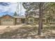 Inviting front exterior of a single-story home with mature landscaping and an attached two car garage at 19475 Stag Ln, Monument, CO 80132