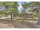 Single story home with lush landscaping and mature trees surrounding the exterior at 19475 Stag Ln, Monument, CO 80132