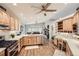 Spacious kitchen features wood cabinets, stainless appliances, an eat-in island, and views to the dining and living room at 19475 Stag Ln, Monument, CO 80132