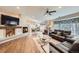 Open concept living room and dining room with hardwood floors, fireplace and natural light at 19475 Stag Ln, Monument, CO 80132