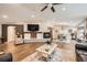 Open concept living room and dining room with fireplace, hardwood floors and natural light at 19475 Stag Ln, Monument, CO 80132
