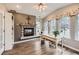 Sunlit office with a fireplace, vaulted ceilings, a wall of windows, and luxury vinyl flooring at 19475 Stag Ln, Monument, CO 80132