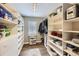 Large walk-in closet with custom built-in shelving and drawers at 19475 Stag Ln, Monument, CO 80132