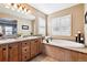 Bathroom with double vanity, soaking tub, and large mirror at 10654 Ashfield St, Highlands Ranch, CO 80126