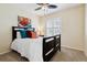 Guest bedroom with queen bed, ceiling fan and window shutters at 10654 Ashfield St, Highlands Ranch, CO 80126