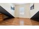 Bright bedroom featuring wood flooring and a window with shutters at 10654 Ashfield St, Highlands Ranch, CO 80126