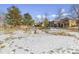 Snow-covered park with benches and large rocks in a residential neighborhood at 10654 Ashfield St, Highlands Ranch, CO 80126