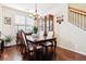 Bright dining room with hardwood floors, chandelier, and seating for four at 10654 Ashfield St, Highlands Ranch, CO 80126