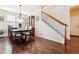 Formal dining room features hardwood floors, chandelier, and built-in hutch at 10654 Ashfield St, Highlands Ranch, CO 80126