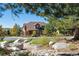 Two-story home with stone accents and landscaping in a residential neighborhood at 10654 Ashfield St, Highlands Ranch, CO 80126