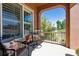 Inviting front porch with two chairs and a small table at 10654 Ashfield St, Highlands Ranch, CO 80126