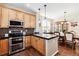 Kitchen with island, hardwood floors, and dining area at 10654 Ashfield St, Highlands Ranch, CO 80126