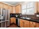 Modern kitchen with stainless steel appliances and double sink at 10654 Ashfield St, Highlands Ranch, CO 80126