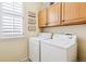 Laundry room with washer, dryer, and upper cabinets at 10654 Ashfield St, Highlands Ranch, CO 80126