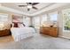 Spacious main bedroom with carpeted floor, ceiling fan, and large dresser at 10654 Ashfield St, Highlands Ranch, CO 80126