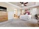 Main bedroom with ensuite bathroom access and ceiling fan at 10654 Ashfield St, Highlands Ranch, CO 80126