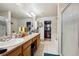 Spacious bathroom with dual sinks, large mirrors, walk-in shower, and separate soaking tub at 7131 S Wenatchee Way # F, Aurora, CO 80016