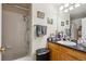 A full bathroom features a shower-tub combination, with vanity and granite countertop at 7131 S Wenatchee Way # F, Aurora, CO 80016