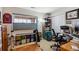 A bedroom featuring a parquet floor, a large window, desk, bookcase and an athletic barre at 7131 S Wenatchee Way # F, Aurora, CO 80016