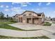 Beautiful exterior of a townhouse featuring stone accents, multiple garages, and well-maintained landscaping at 7131 S Wenatchee Way # F, Aurora, CO 80016