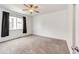 Well-lit bedroom features a ceiling fan and large window at 15955 E Geddes Dr # 55, Aurora, CO 80016