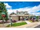 Community clubhouse with stone facade, well-manicured landscaping, and inviting entrance at 15955 E Geddes Dr # 55, Aurora, CO 80016